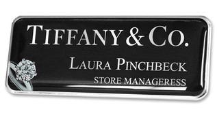 A black plastic executive name badge with the leyend: "Thiffany & Co."